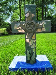 Aztec imagery, courtesy of acrylic paint, some old CDs, and modeling clay made from cornstarch, baking powder, and water. The things on this side of the cross were all symbols important to native Mesoamerican spirituality, and were adapted by missionaries to fit in Christian teachings too. Mirrors represented a connection to a different dimension or world. Corn was a sacred substance, subsequently used to make human forms of Jesus that were hung on ceremonial crosses. The Nahuatl people were also taught to say the equivalent of 